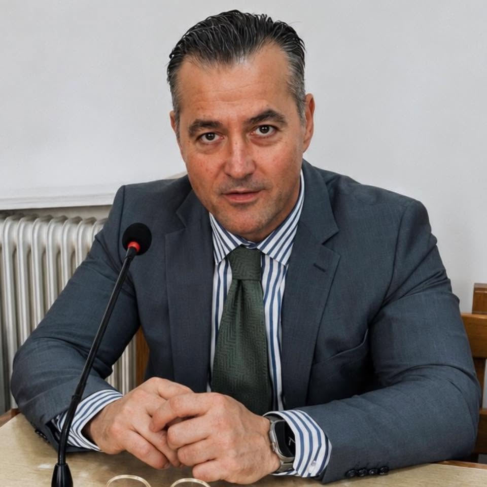 Nikolaos Zindros Nikolaos S. Zindros speaking at a microphone